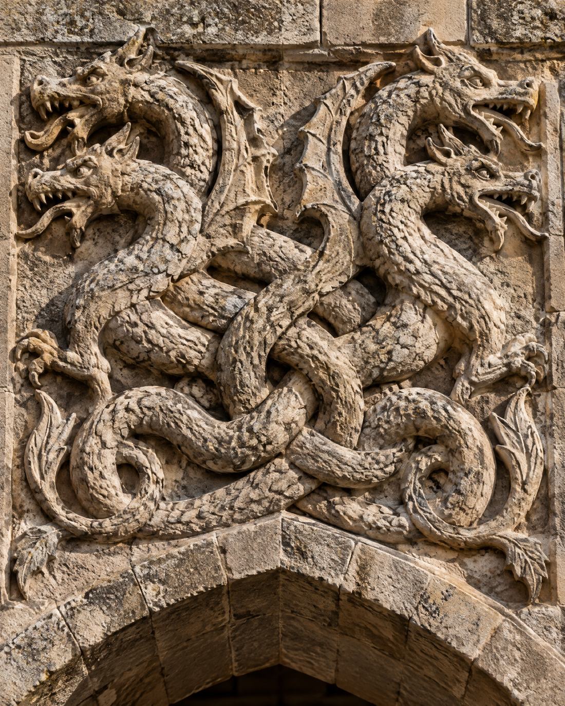A stone relief of two intertwined two-headed dragons