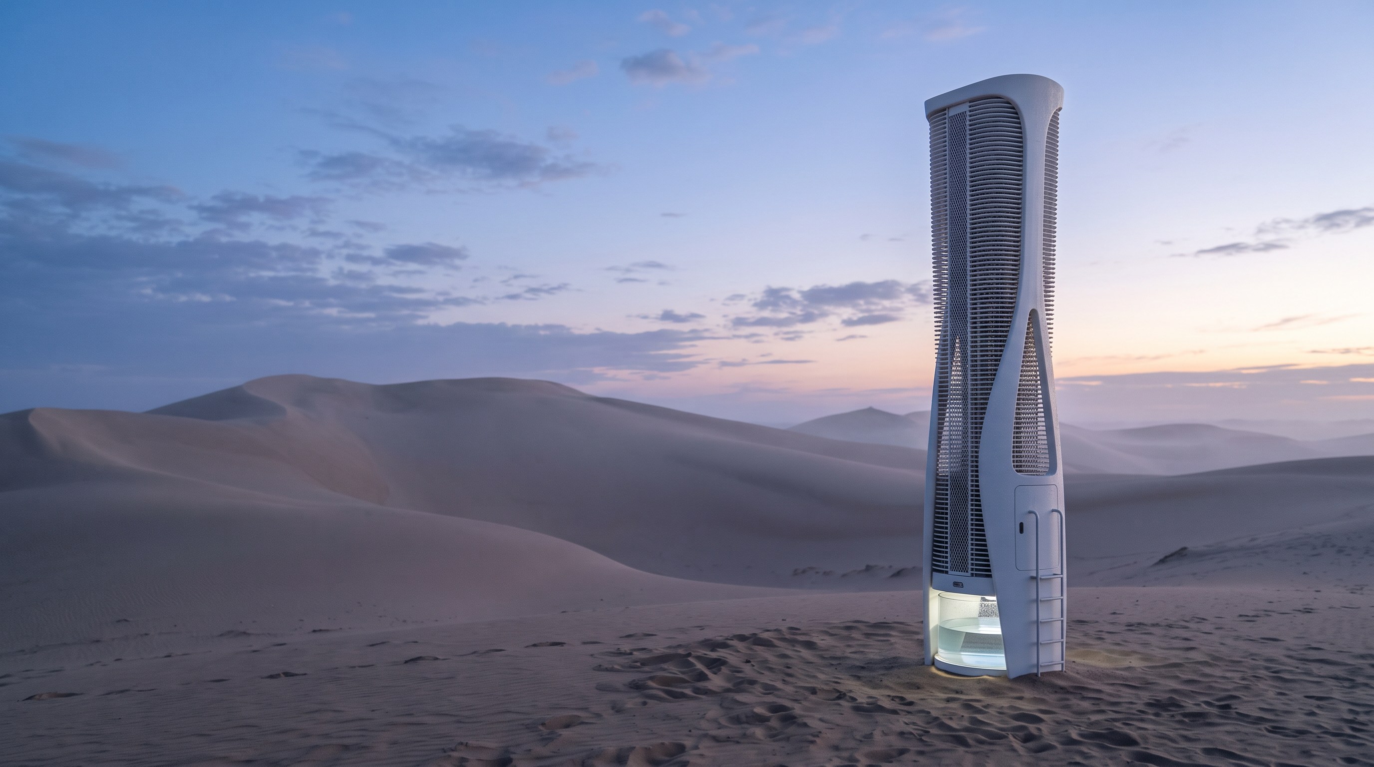 A white Dewline water harvesting tower standing alone in desert dunes before dawn, its lit reservoir glowing at the base